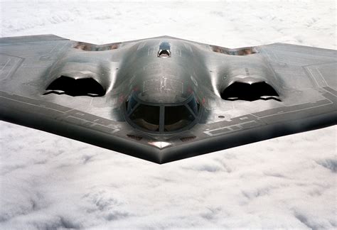 Northrop Grumman B-2 Spirit stealth bomber flying wing design over runway