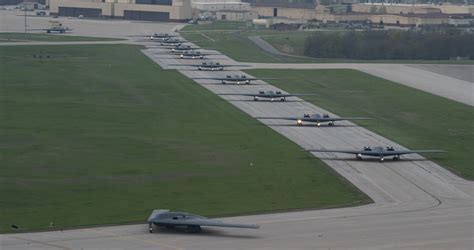 Northrop Grumman B-2 Spirit taxiing at Whiteman Air Force Base under maintenance crew observation