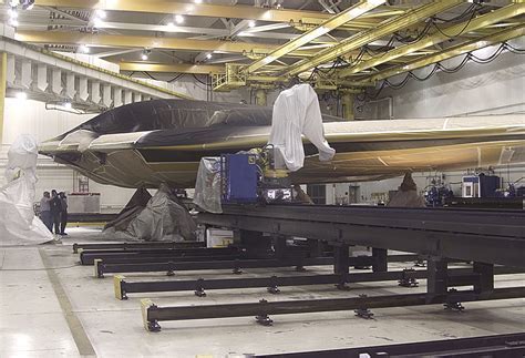 northrop grumman engineers inspecting b-2 stealth coating in controlled facility