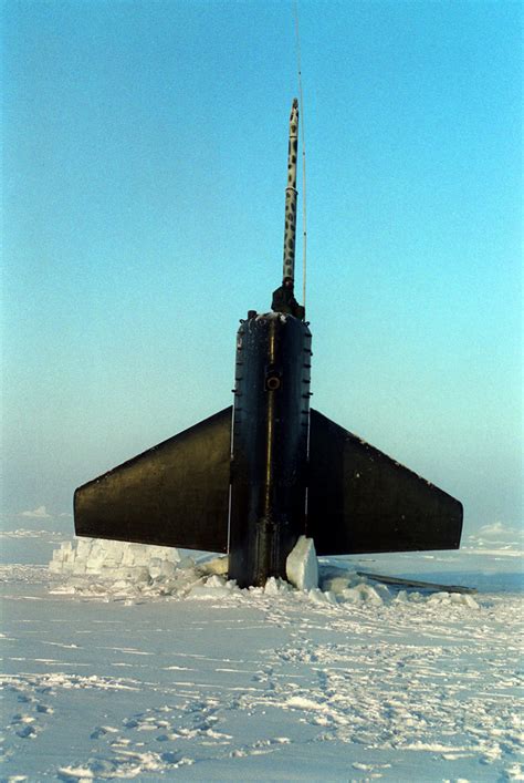 Ohio-class submarine surfacing through Arctic ice with crew on deck