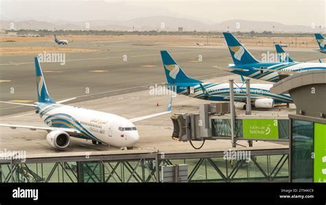 Oman Air aircraft in new livery at Muscat International Airport gate