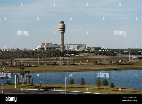Orlando International Airport control tower with aircraft operations in background