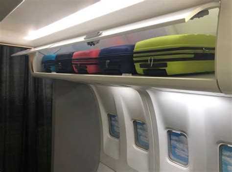 overhead storage bin showing travel pram placement struggles on narrow-body jet