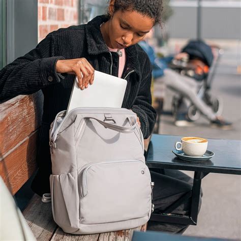 Pacsafe V Anti-Theft backpack being locked to a chair at a café