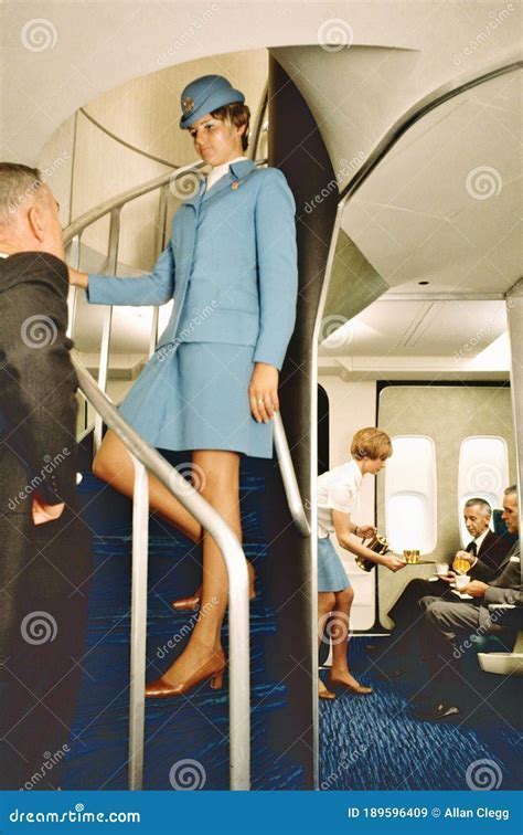 Pan Am flight attendant in classic uniform serving passengers in a Boeing 747 cabin