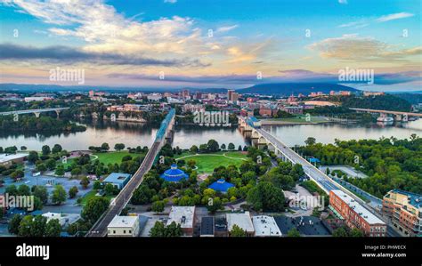 panoramic helicopter view of Chattanooga skyline, Tennessee River, and surrounding mountains at sunset