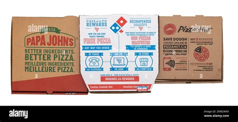 Papa Johns pizza boxes beside Spirit Airlines themed travel items and loyalty cards