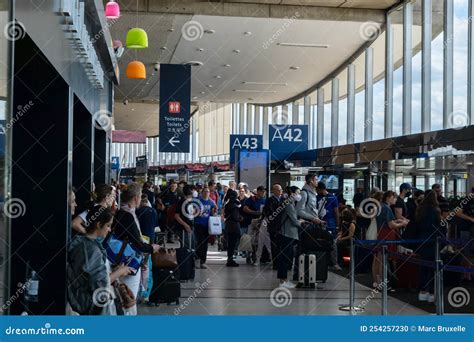Paris Charles de Gaulle airport departure hall Air France check-in counters busy passengers