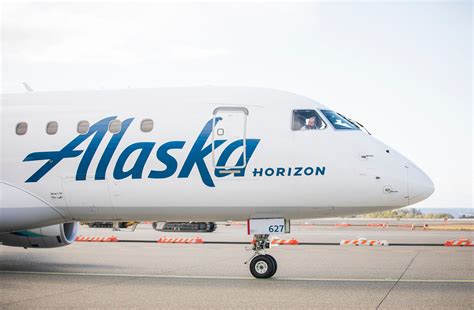 parked Horizon Air and Alaska Airlines planes idle at regional terminal gate
