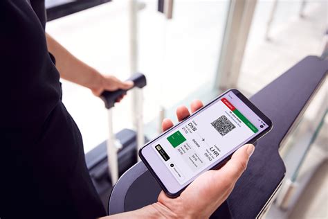 passenger checking airline mobile app upgrade offer on smartphone inside airport terminal