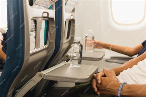 passenger drinking water during overnight international flight cabin