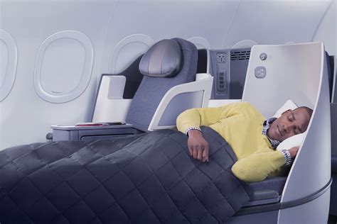 passenger sleeping lie flat seat airplane night window