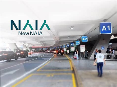 passenger terminal entrance showing shuttle buses, taxis, and private vehicles at curbside
