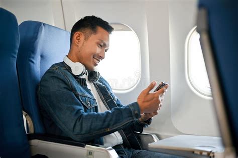 passenger using smartphone airplane cabin