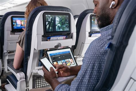 passenger using tablet onboard wifi entertainment airplane BYOD streaming interface