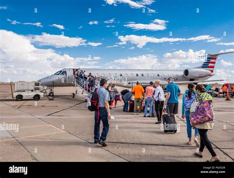 passengers boarding American Airlines jet at sunset at VPS airport