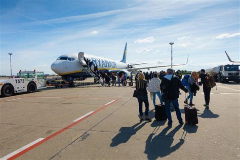 passengers boarding low-cost aircraft at secondary European airport terminal