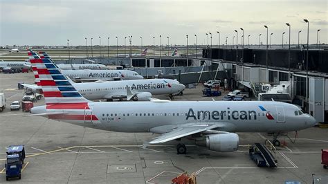 passengers boarding united airlines flight to sunny destination at chicago o’hare in fall attire