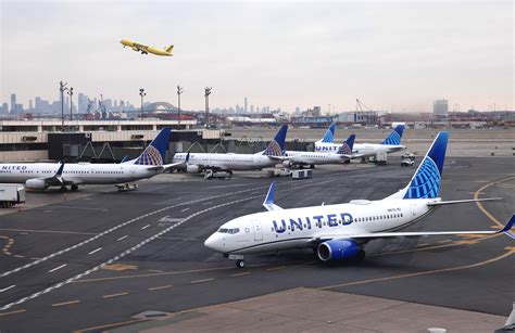 passengers checking departure boards during Newark peak-hour delays