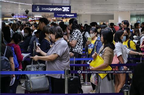 passengers in line at a European airport during peak season delays