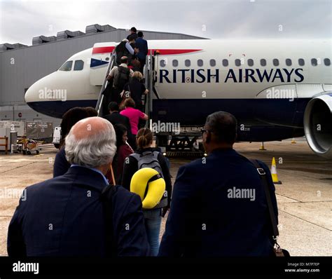 passengers queuing at heathrow with airline branding visible
