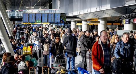 passengers waiting at amsterdam schiphol after klm cancellations