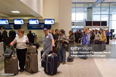 passengers waiting at united rebooking counter houston airport