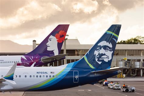 passengers waiting near silent Alaska Airlines gate amid ongoing national suspension