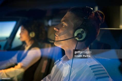 passengers wearing headsets inside helicopter during sunset flight over Ohio Stadium