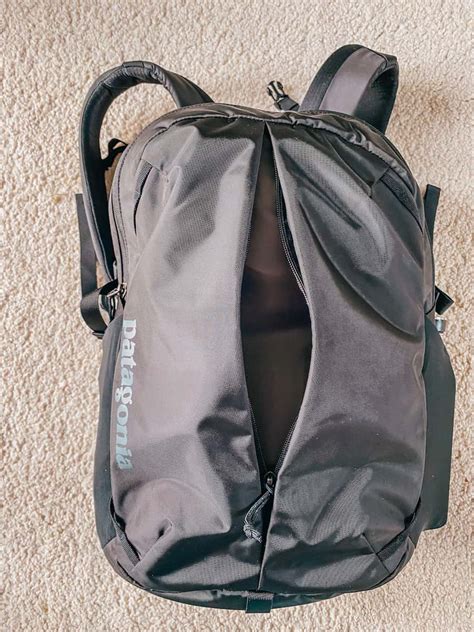 Patagonia Refugio 26L resting on airport floor with side pocket used