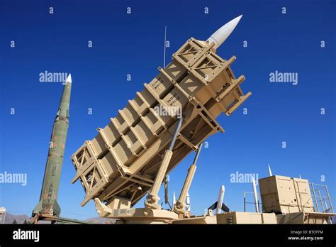 Patriot missile battery stationed in Guam with naval radar array in background