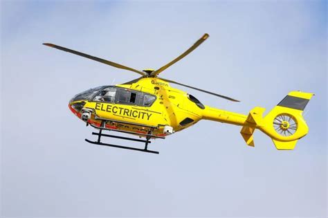 PG&E utility helicopter flying low over power lines in Red Bluff, California