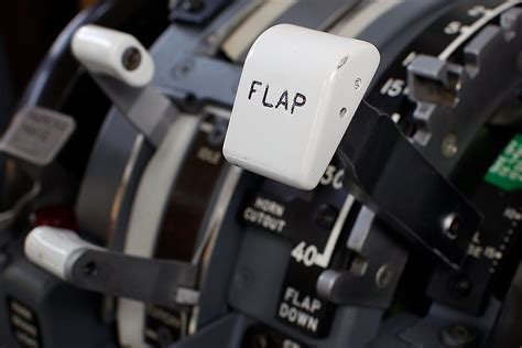 pilot adjusting flap lever and verifying engine parameters on hold during stop-and-go