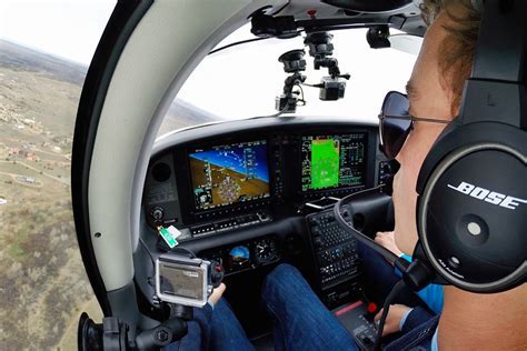 pilot cockpit view preparing to land at towered airport, base to final turn