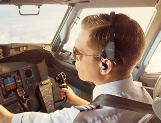 Pilot in cockpit wearing an advanced aviation headset