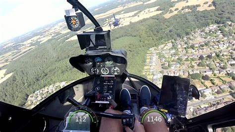 pilot in final assessment flight test inside r44 cockpit over victoria harbour