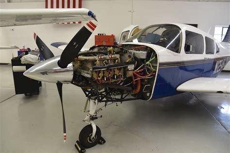 Piper Arrow undergoing routine maintenance in hangar