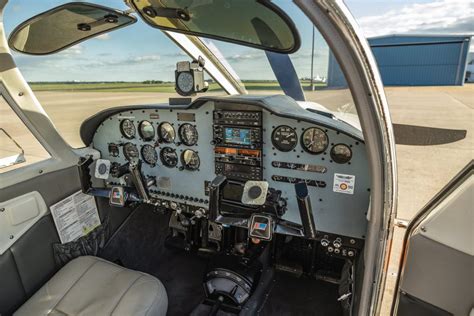 Piper Cherokee 235 with original panel and paint, parked on grass strip