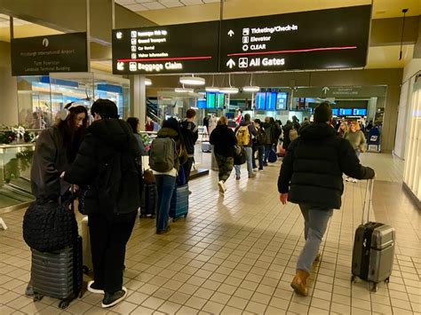 Pittsburgh International Airport terminal bustling with international travelers