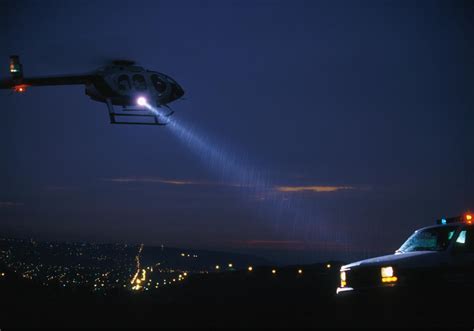 police helicopter monitoring city streets during night operation