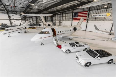 private jet parked in FBO hangar with IS-BAO Stage III banner visible