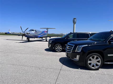 private jet parked outside luxury FBO with fuel truck nearby