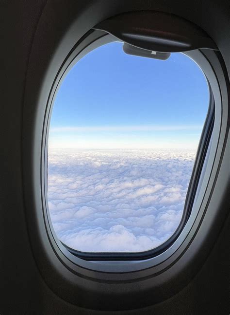 private jet window view over the Alps with tinted glass panel
