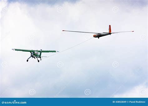 private pilot towing a glider on runway with light aircraft
