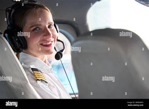 private pilot with headset smiling inside cockpit during golden hour flight