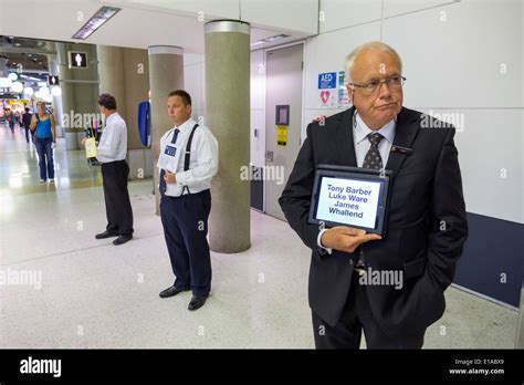 Professional driver holding a personalized name sign in airport arrival hall