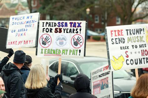 Protest signs at Southwest ticket counters demanding protection of the Companion Pass perk