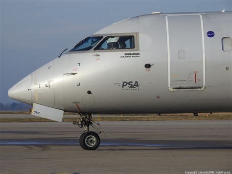 PSA Airlines Bombardier CRJ parked on taxiway at sunrise