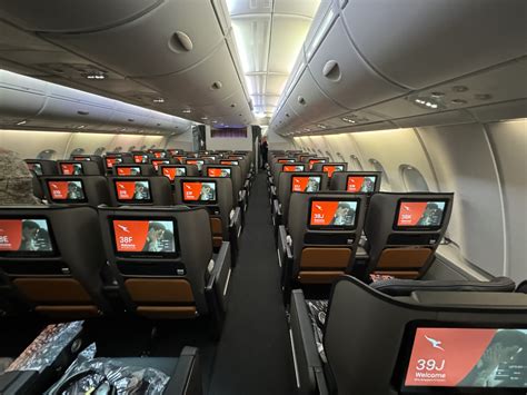 qantas a380 economy class cabin with ambient lighting and personal screens