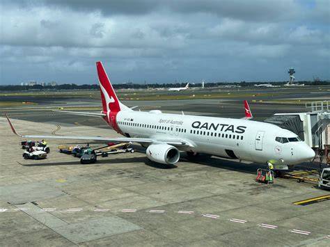 Qantas Airbus A321 and Boeing 737 taxiing near Sydney Airport terminal and runway intersections